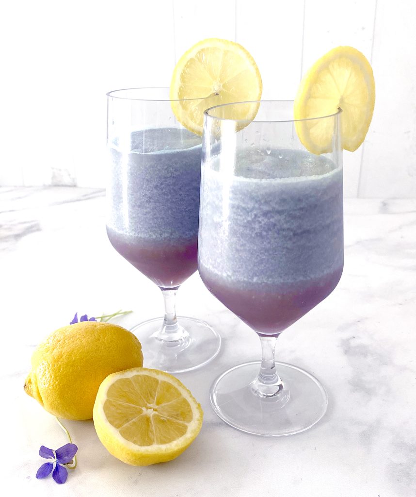 two glasses of frozen violet lemonade made at home